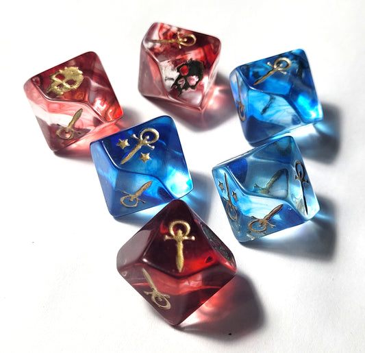 Set of red and blue dice with gold symbols on a white background