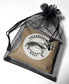 Brown, packaged order in a drawstring bag with 'The Cerulean Wolf' label on a white background
